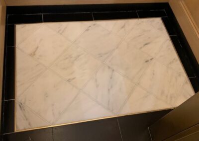 White marble and black granite samples used for custom stone fabrication by Marble Lite Inc. in NYC.